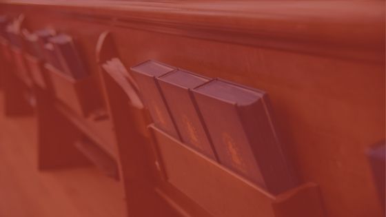 Close-up image of pews in a church with red overlay