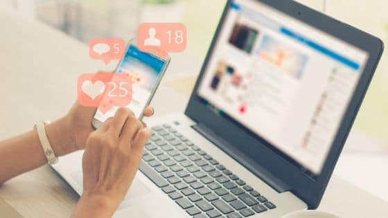 A woman scrolls through her social media feed